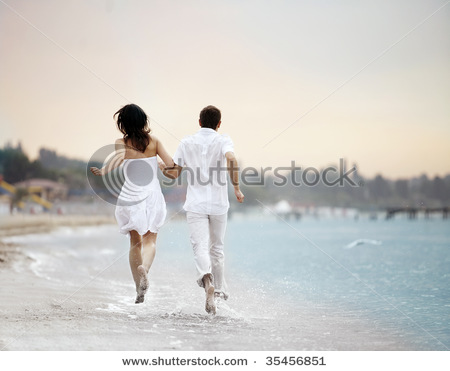 Miłość - stock-photo-couple-holding-hands-running-away-over-the-beach-35456851.jpg